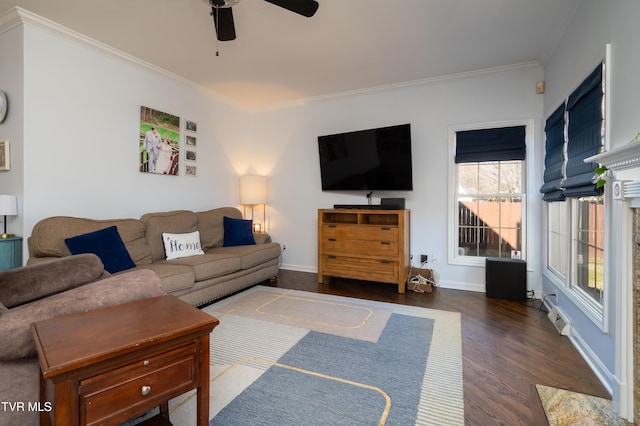 living area with a ceiling fan, crown molding, baseboards, and wood finished floors