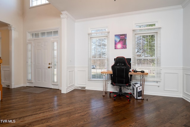 entrance foyer featuring decorative columns and a wealth of natural light