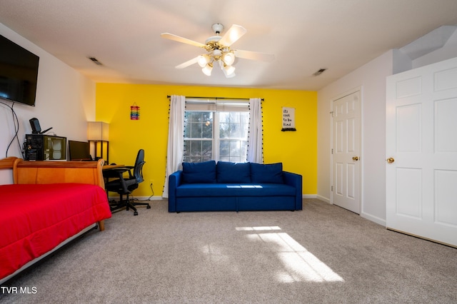 carpeted bedroom featuring a ceiling fan, visible vents, and baseboards