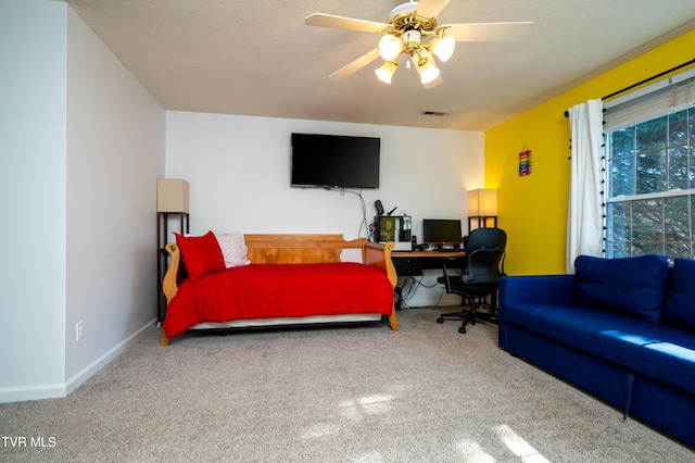 bedroom featuring a textured ceiling, carpet floors, a ceiling fan, visible vents, and baseboards