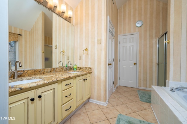 bathroom featuring a closet, tile patterned floors, a sink, and wallpapered walls