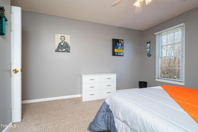 bedroom with carpet flooring, ceiling fan, a textured ceiling, and baseboards