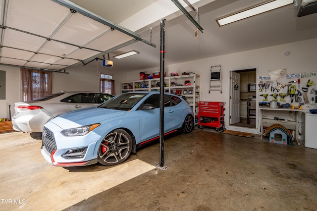 garage featuring a garage door opener, electric panel, and a workshop area