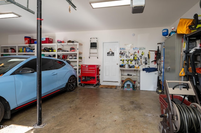 garage featuring a workshop area and a garage door opener