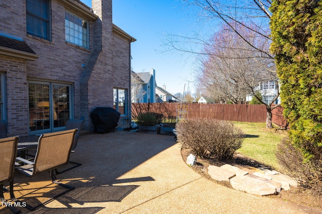 view of patio / terrace featuring area for grilling and fence