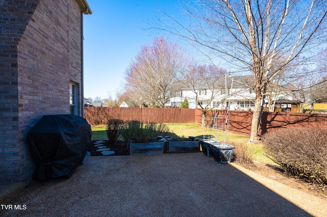 view of patio featuring fence and area for grilling