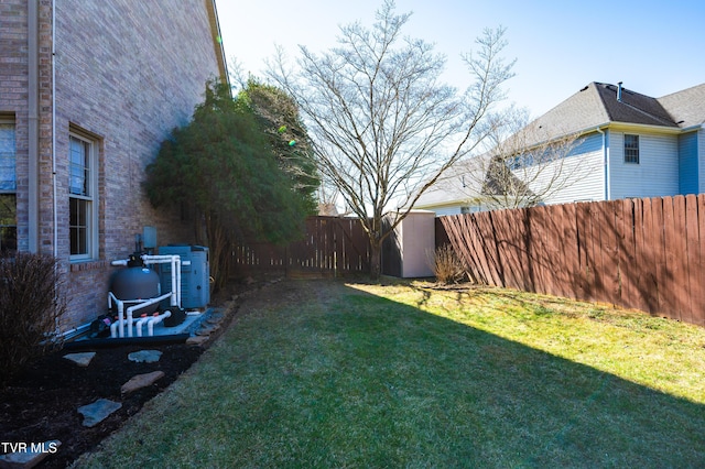 view of yard with a fenced backyard and an outbuilding