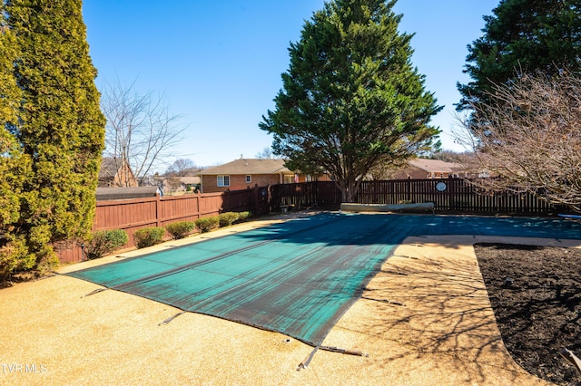 view of pool featuring fence