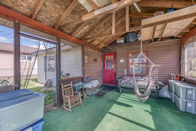 sunroom / solarium featuring lofted ceiling