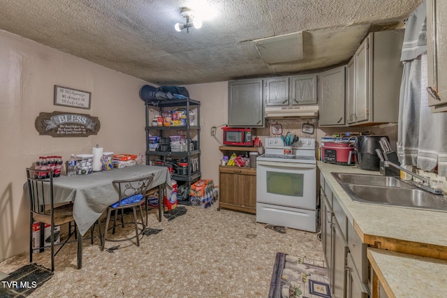 kitchen featuring white range with electric cooktop, light floors, light countertops, under cabinet range hood, and a sink