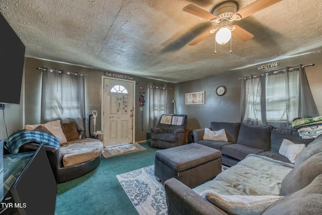 carpeted living room with a ceiling fan and a textured ceiling