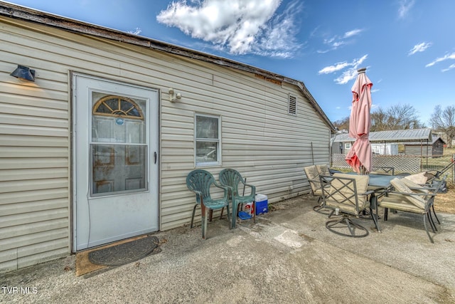 view of patio featuring fence and outdoor dining area