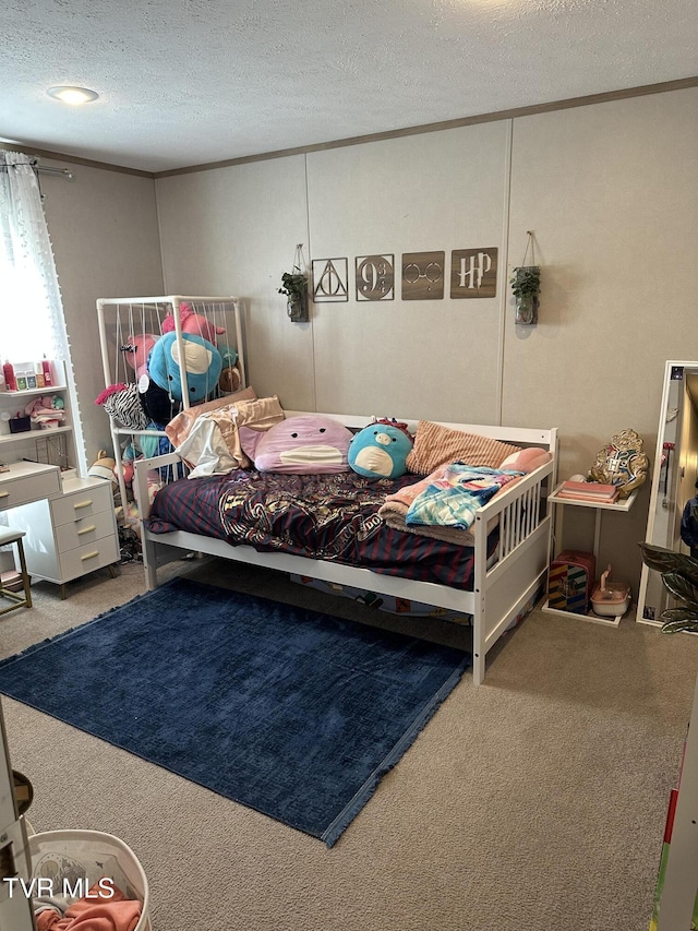 bedroom featuring carpet and a textured ceiling