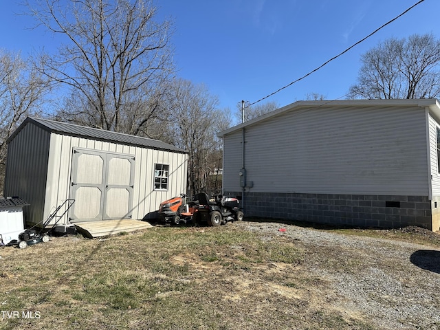 exterior space featuring crawl space, an outdoor structure, and a storage unit