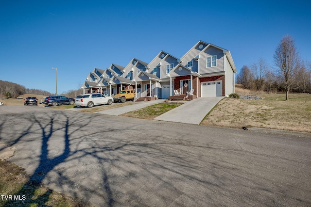 view of front of home featuring concrete driveway, brick siding, and an attached garage