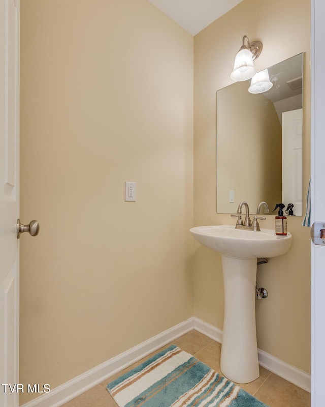 bathroom with baseboards and tile patterned floors