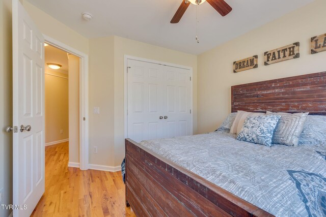 bedroom with a ceiling fan, a closet, baseboards, and light wood finished floors