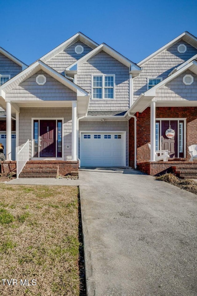 view of front of property featuring covered porch, driveway, and an attached garage