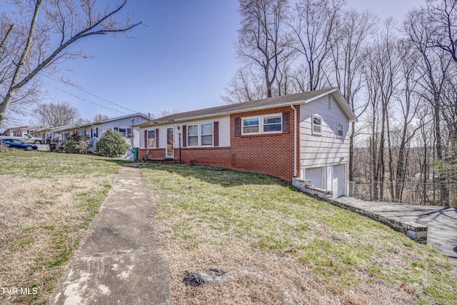 single story home with a garage, driveway, a front yard, and brick siding