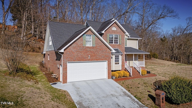 traditional-style house featuring a front lawn, a porch, concrete driveway, a shingled roof, and brick siding