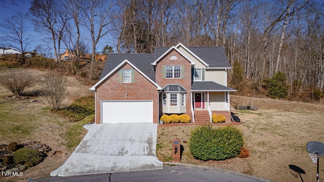 traditional home with a porch, brick siding, a garage, and driveway