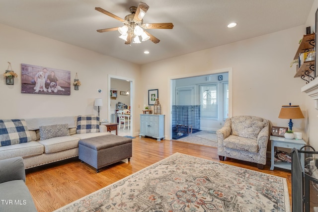 living area featuring recessed lighting, light wood-style floors, and a ceiling fan