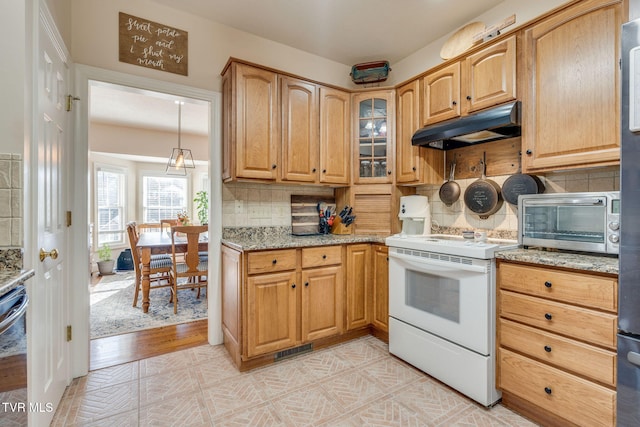 kitchen with under cabinet range hood, visible vents, light stone counters, and white electric range oven