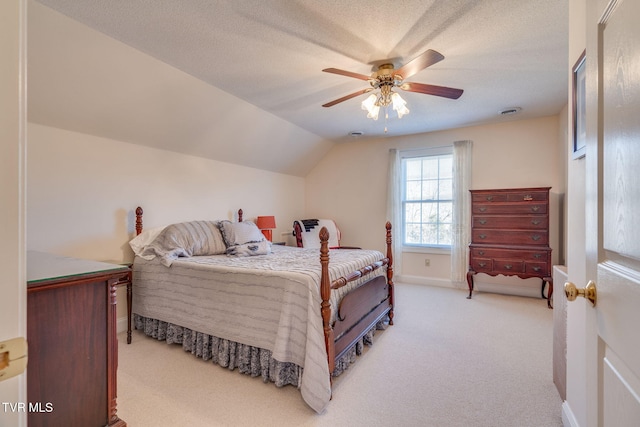 bedroom featuring ceiling fan, a textured ceiling, lofted ceiling, and carpet