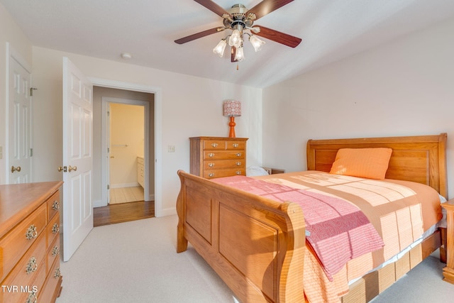 bedroom featuring light colored carpet, baseboards, and ceiling fan