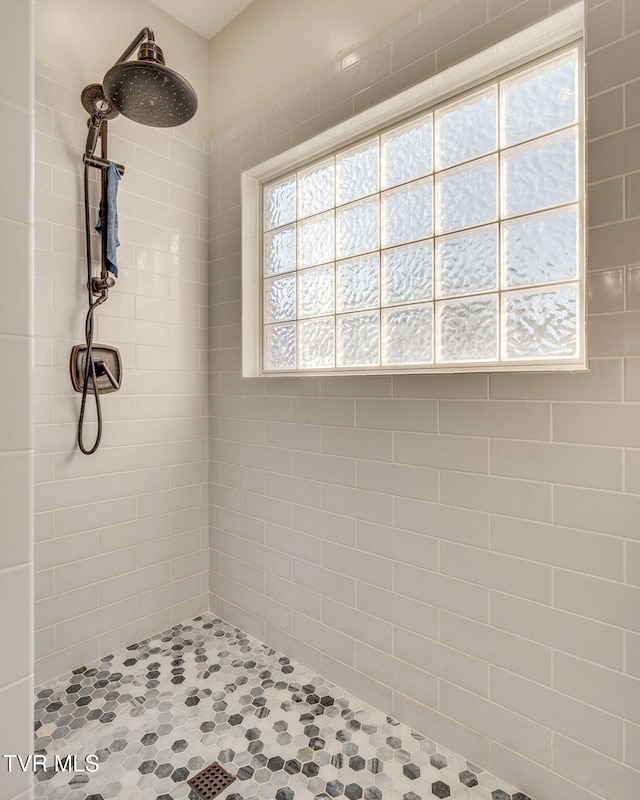 bathroom with a tile shower