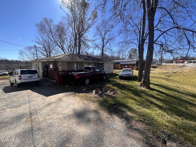 view of front of property with a front yard and driveway