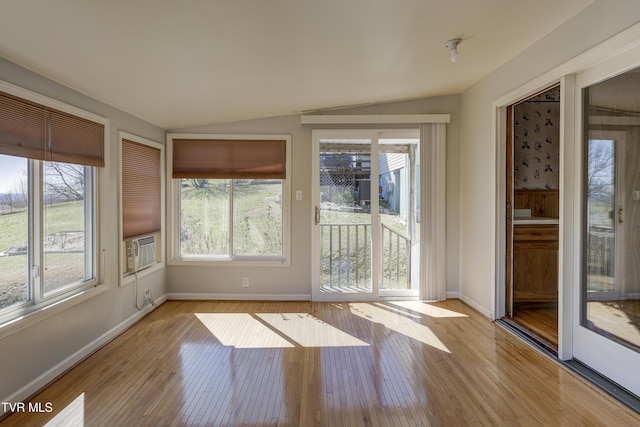 unfurnished sunroom with lofted ceiling, a healthy amount of sunlight, and cooling unit