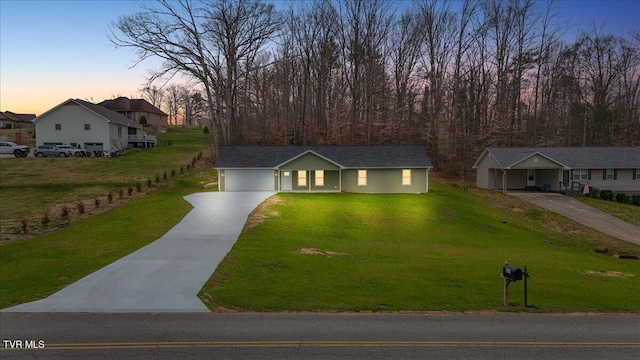 ranch-style home with an attached garage, driveway, and a front lawn