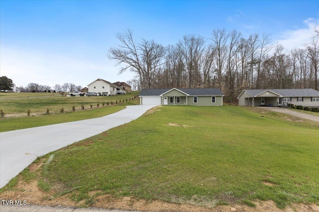 ranch-style home with a garage, concrete driveway, and a front yard