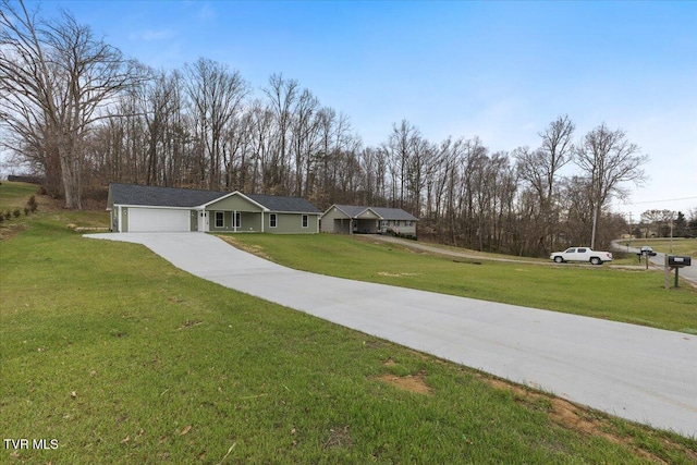 single story home with a garage, a front yard, and driveway