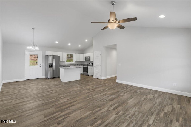 kitchen with a center island, stainless steel appliances, dark wood-type flooring, open floor plan, and white cabinetry