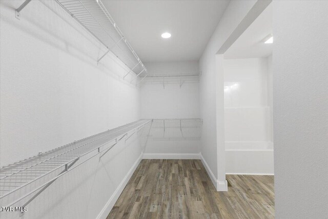 spacious closet with wood finished floors