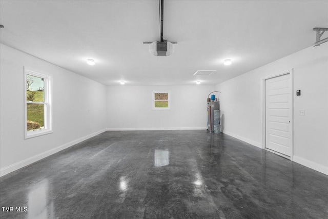 garage featuring a garage door opener, water heater, and baseboards