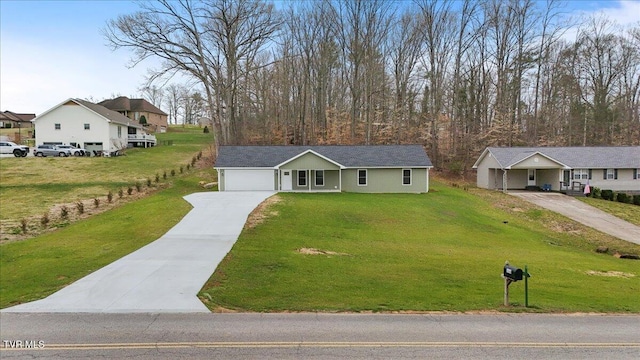 single story home featuring concrete driveway, an attached garage, and a front lawn