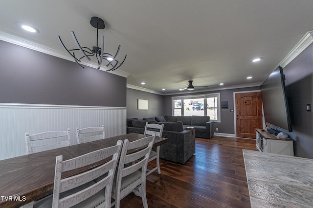 dining area with a wainscoted wall, ornamental molding, dark wood-type flooring, and recessed lighting