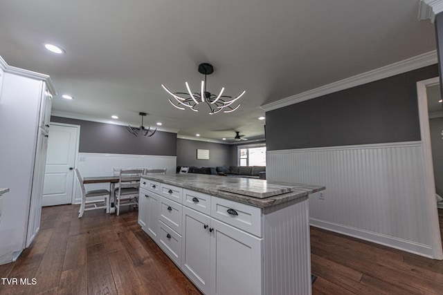 kitchen with a wainscoted wall, a notable chandelier, white cabinetry, and dark wood-type flooring