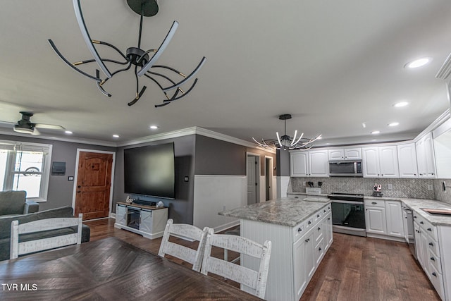 kitchen featuring dark wood-style floors, appliances with stainless steel finishes, and white cabinets