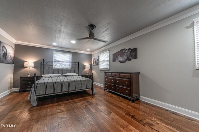 bedroom with ceiling fan, a textured ceiling, baseboards, wood-type flooring, and crown molding