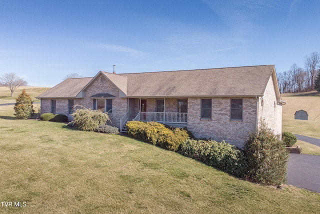 single story home with a front yard, a porch, brick siding, and roof with shingles