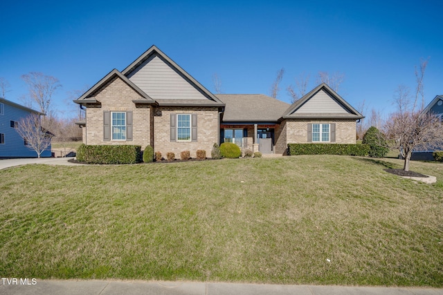 view of front of property featuring a front yard and brick siding