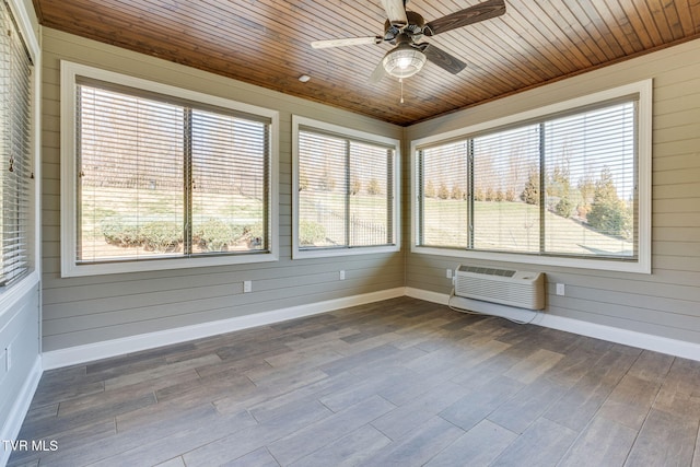 unfurnished sunroom featuring wood ceiling, a ceiling fan, and a wall mounted AC