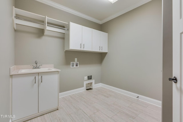 laundry area featuring hookup for a washing machine, cabinet space, a sink, and baseboards