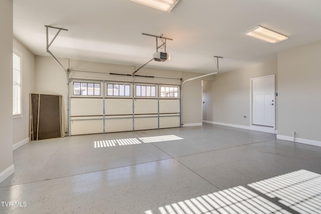 garage with a garage door opener and baseboards