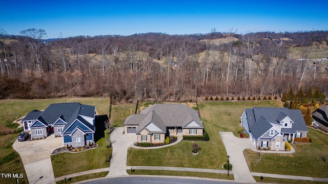 drone / aerial view featuring a wooded view