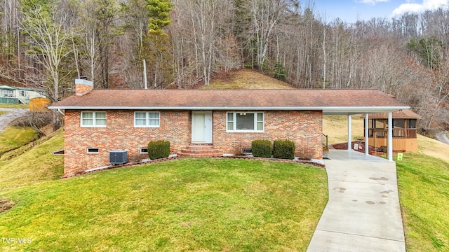 ranch-style house with brick siding, a front lawn, concrete driveway, central AC, and a chimney